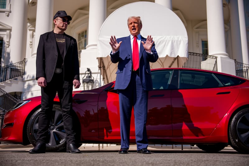 President Donald Trump, accompanied by Elon Musk, speaks next to a Tesla Model S on the South Lawn of the White House on March 11, 2025 in Washington, DC.