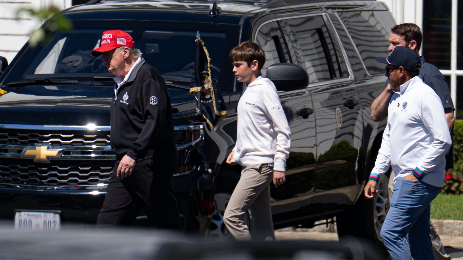 WASHINGTON, DC - AUGUST 30: U.S. President Donald Trump walks with his grandchild Spencer Trump after golfing at Trump National Golf Club on August 30, 2025 in Washington, DC. Trump is spending his Labor Day weekend in Washington, DC after deploying the National Guard to Washington this month. (Photo by Kayla Bartkowski/Getty Images)