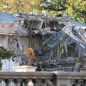 Workers demolish the facade of the East Wing of the White House on Oct. 20, 2025 in Washington, DC. The demolition is part of U.S. President Donald Trump's plan to build a ballroom reportedly costing $250 million on the eastern side of the White House.