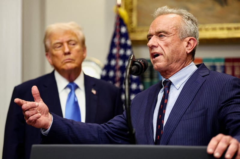 U.S. Secretary of Health and Human Services Robert F. Kennedy Jr. delivers remarks while U.S. President Donald Trump listens during a press conference to announce a link between autism and childhood vaccines and the use of popular pain medication Tylenol for pregnant women and children, claims which are not backed by decades of science, at the White House in Washington, D.C., U.S., September 22, 2025. REUTERS/Kevin Lamarque