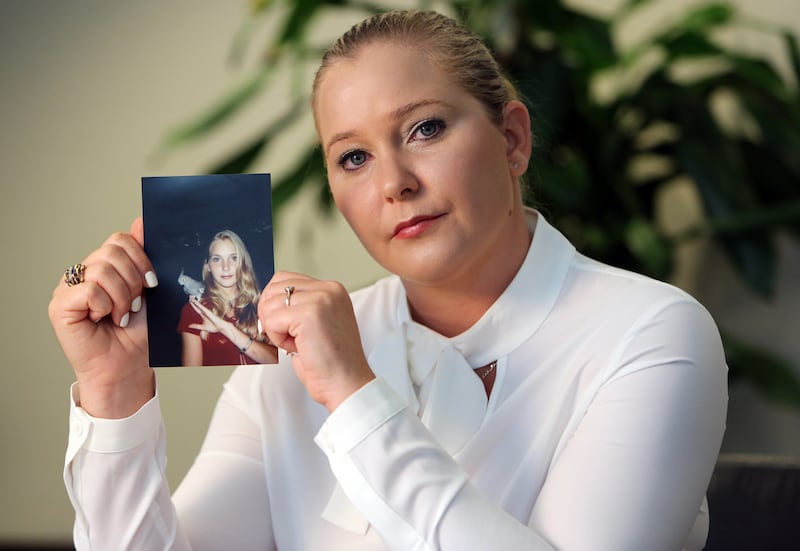 Virginia Roberts holds a photo of herself at age 16, when she says Palm Beach multimillionaire Jeffrey Epstein began abusing her sexually.
(Emily Michot/Miami Herald/Tribune News Service via Getty Images)