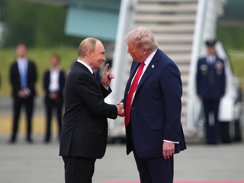 President Donald Trump (R) greets Russian President Vladimir Putin as he arrives at Joint Base Elmendorf-Richardson on August 15, 2025 in Anchorage, Alaska.