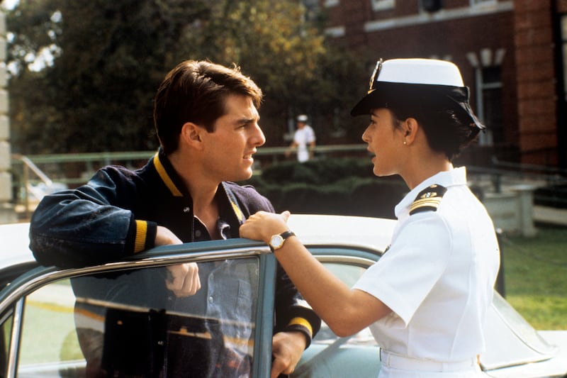 American actress Demi Moore (Demetria Gene Guynes), wearing a navy uniform, talking near a car with American actor Tom Cruise in the film A Few Good Men. 1992