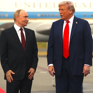 Russian President Putin (L) listens to U.S. President Donald Trump (R) during the welcoming ceremony prior to the meeting on war in Ukraine