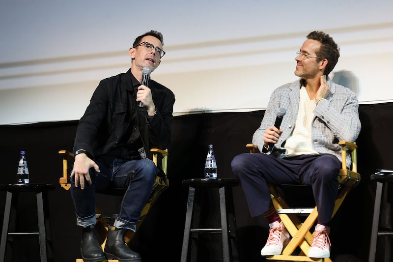 HOLLYWOOD, CALIFORNIA - OCTOBER 02: (L-R) Colin Hanks and Ryan Reynolds speak onstage during John Candy: I Like Me, an evening with Ryan Reynolds at The Montalban on October 02, 2025 in Hollywood, California.  (Photo by Monica Schipper/Getty Images for Maximum Effort and Mills Entertainment)