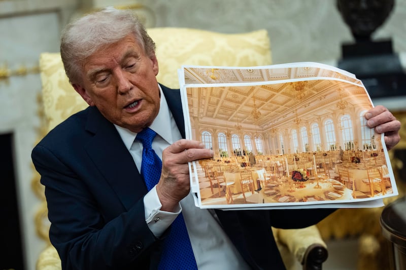 WASHINGTON, DC - OCTOBER 22, 2025: U.S. President Donald Trump speaks holding a photos of the new ballroom during a meeting with NATO Secretary General Mark Rutte in the Oval Office of the White House in Washington, DC on October 22, 2025.