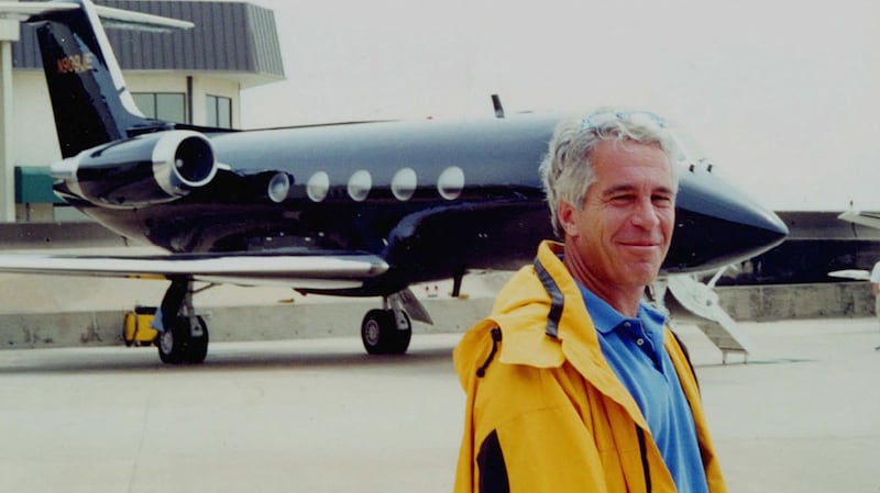 Jeffrey Epstein stands in front of his Gulfstream G550 private jet.