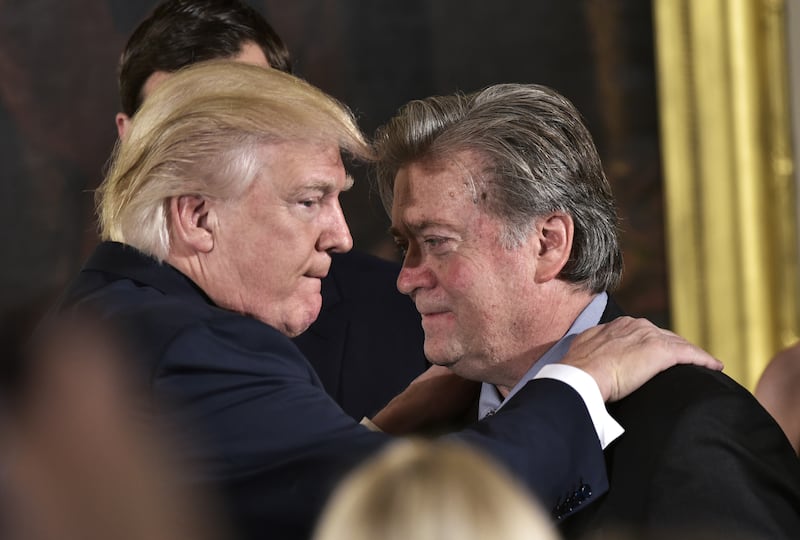 Donald Trump and Steve Bannon during the swearing-in of senior staff in the East Room of the White House on January 22, 2017 in Washington, DC.