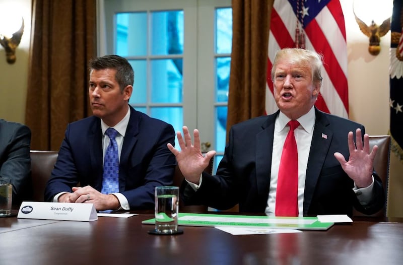 US President Donald Trump, with US Congressman Sean Duffy (L), speaks in the Cabinet Room of the White House on January 24, 2019.