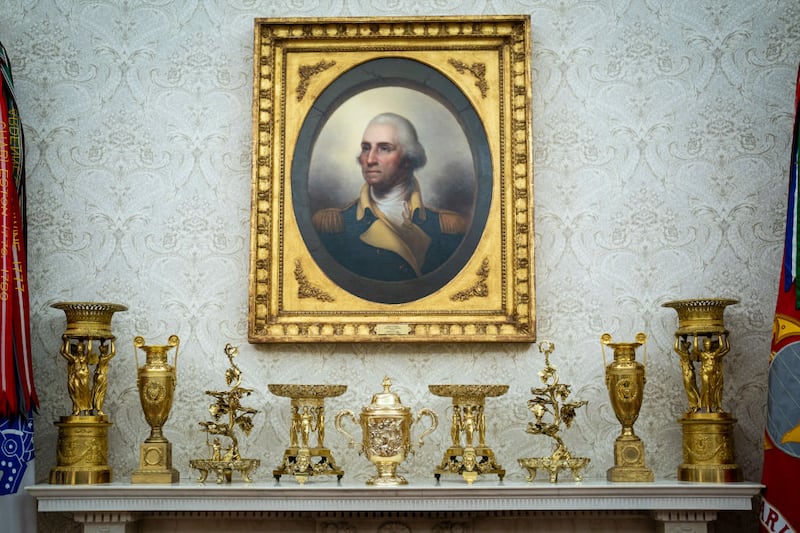 Gold decorations sit on a fireplace mantle as President Donald J Trump speaks in the Oval Office at the White House on Friday, Jan 31, 2025 in Washington, DC.
